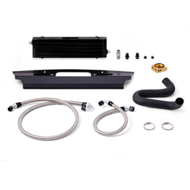 Mishimoto black thermostatic oil cooler kit installed on a 2015+ Ford Mustang GT, featuring durable metal fins and hoses.