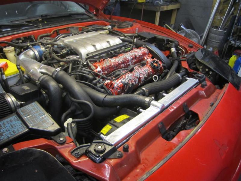 Mishimoto aluminum radiator for 1991-1999 Mitsubishi 3000GT Turbo, manual transmission, with core and fittings visible.