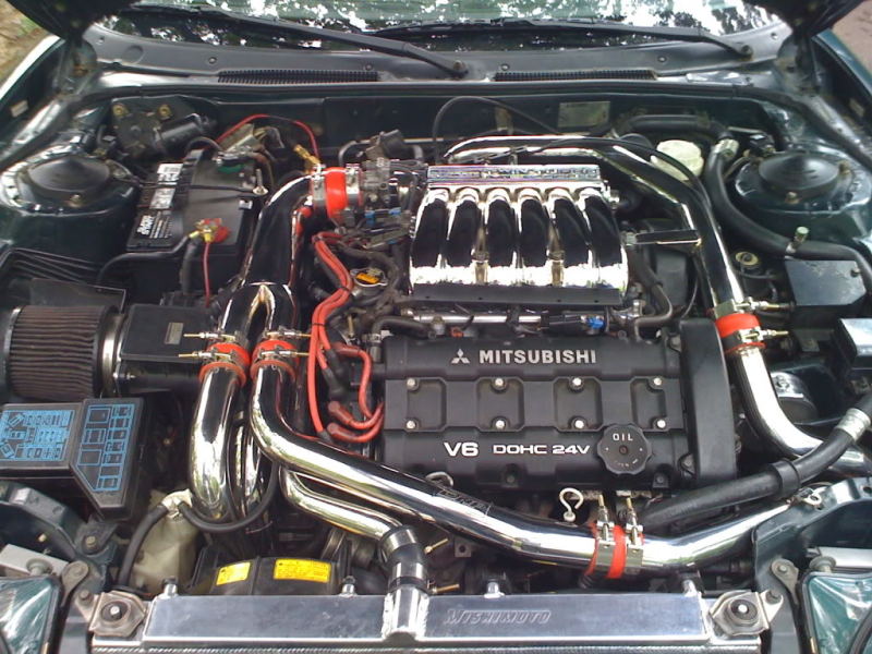 Mishimoto aluminum radiator for 1991-1999 Mitsubishi 3000GT Turbo, featuring a sleek silver design and multiple cooling fins.