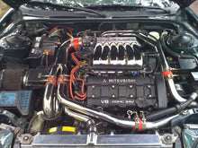 Load image into Gallery viewer, Mishimoto aluminum radiator for 1991-1999 Mitsubishi 3000GT Turbo, featuring a sleek silver design and multiple cooling fins.