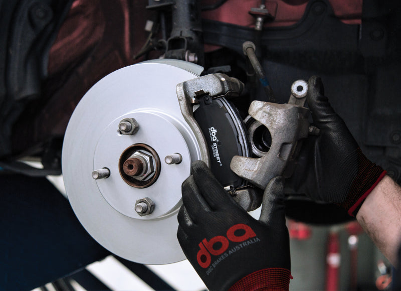DBA rear slotted street series brake rotor for Subaru WRX STi and BRZ with performance package, showcasing slotted stainless steel design.