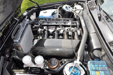 Load image into Gallery viewer, Mishimoto aluminum radiator for 87-91 BMW E30 M3 manual transmission, with cooling fins and mounting brackets visible.