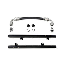 Load image into Gallery viewer, DeatschWerks Chevrolet LS2/LS3 fuel rails with crossover installed on engine, featuring metal finish and precise fit for performance vehicles.