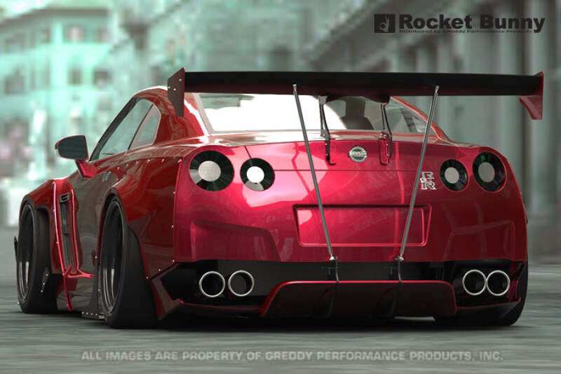 GReddy wide-body aero kit with wing on Nissan GT-R R35, featuring rocket bunny-style fenders and aggressive body modifications.